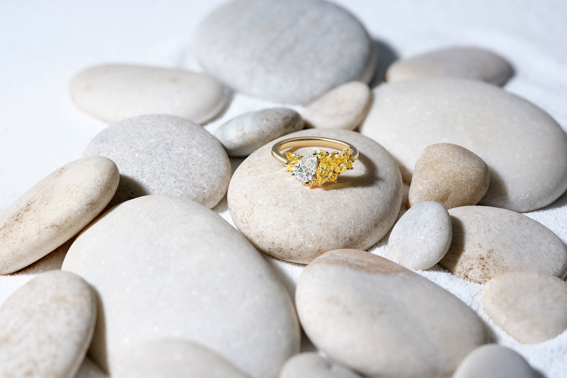 Yellow diamond ring on pebbles