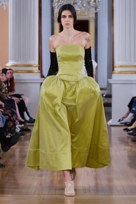 Woman in green Marie Antoinette-style contemporary dress