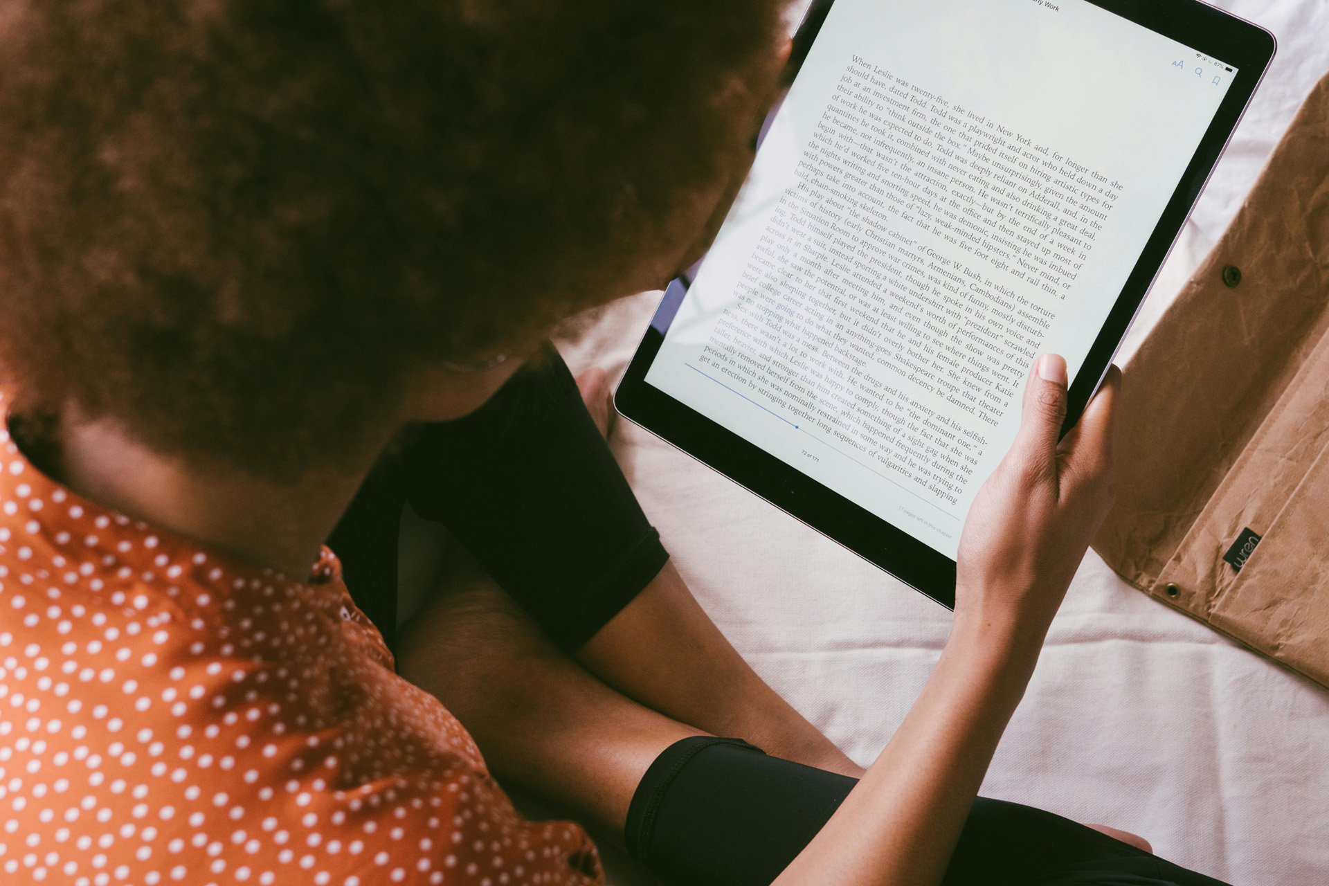 A woman reading an eBook on an iPad