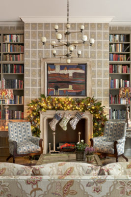 Armchairs beside a fireplace with Christmas stockings