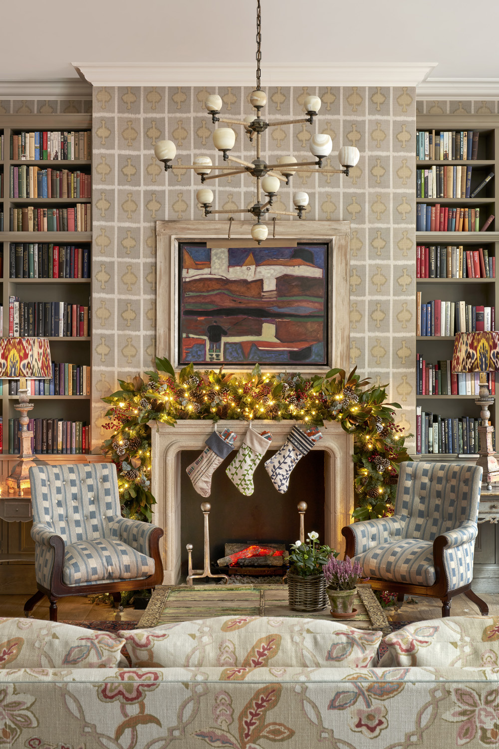 Armchairs beside a fireplace with Christmas stockings