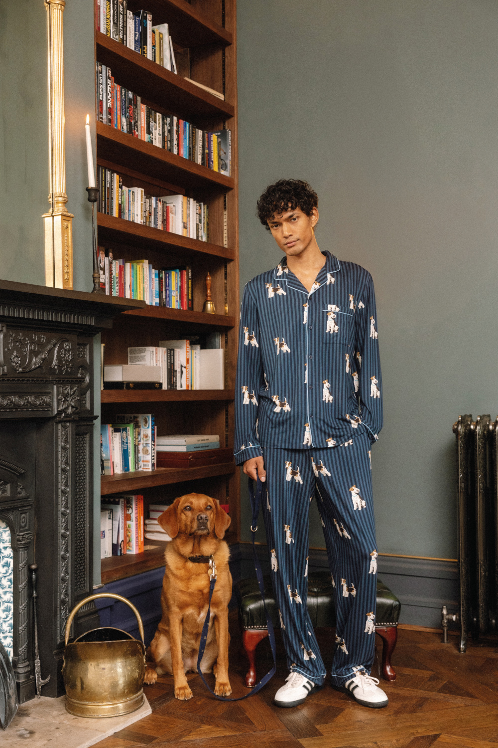 Man in pyjamas stood next to dog