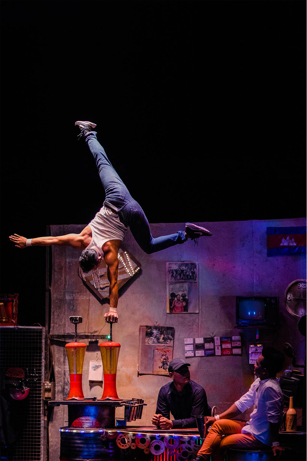 A circus performer at PHARE Circus performs a one armed handstand