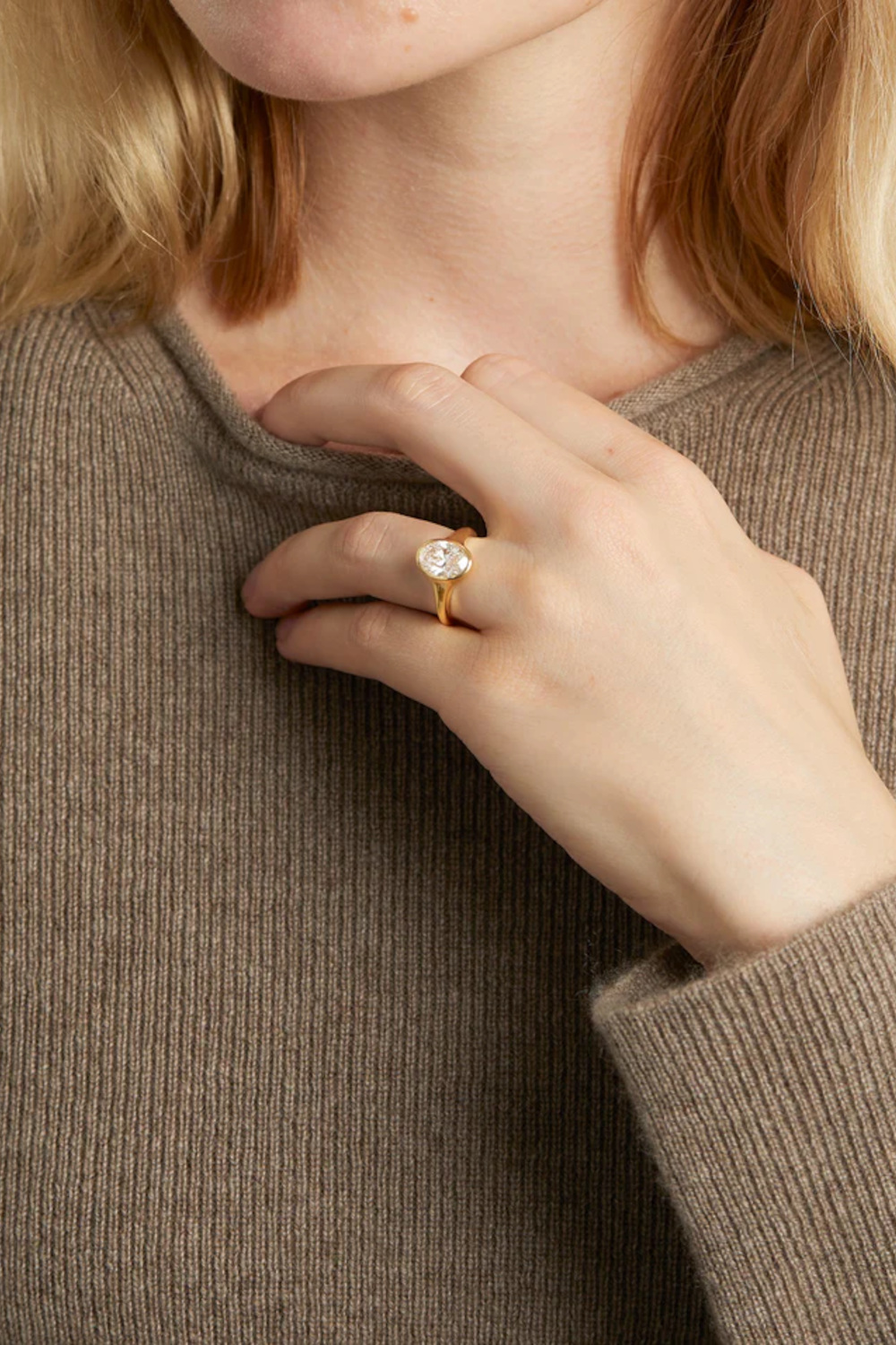 Woman with hand on her chest