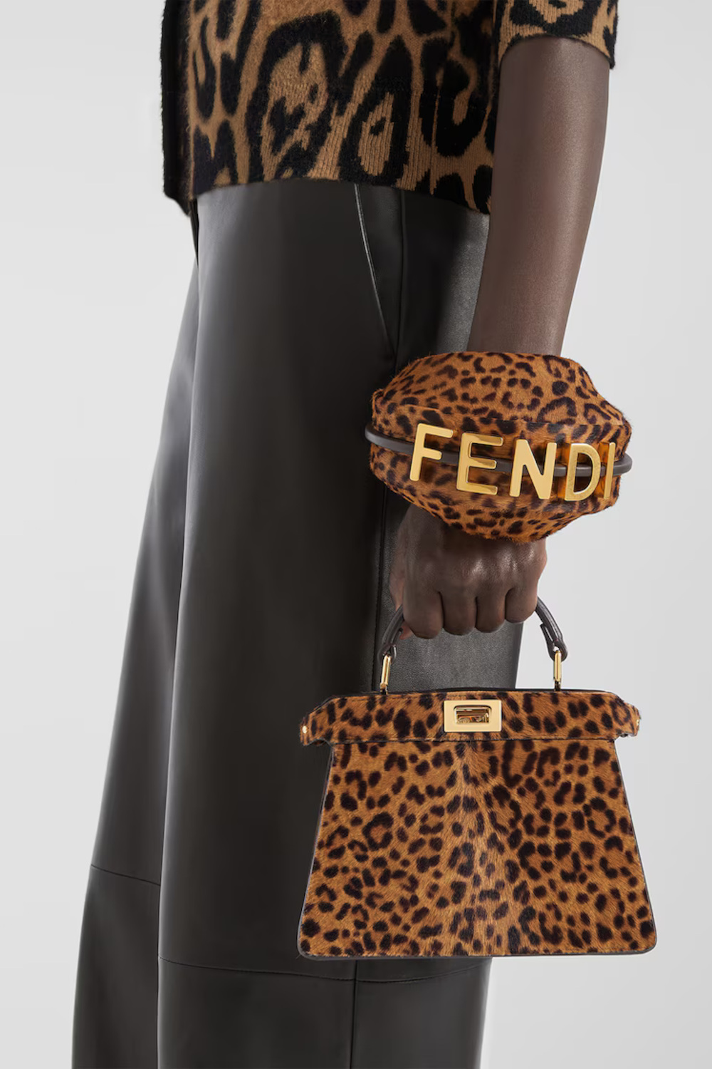 Hand holding leopard print bag