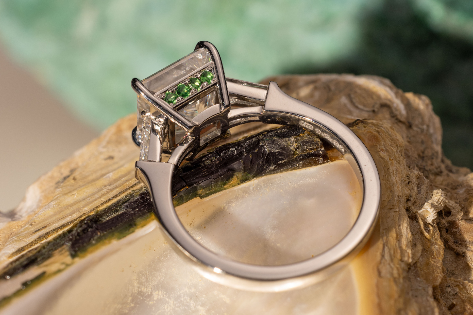 Ring with green stones underneath main stone | engagement ring trends