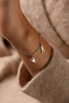 Arm with charm bracelet