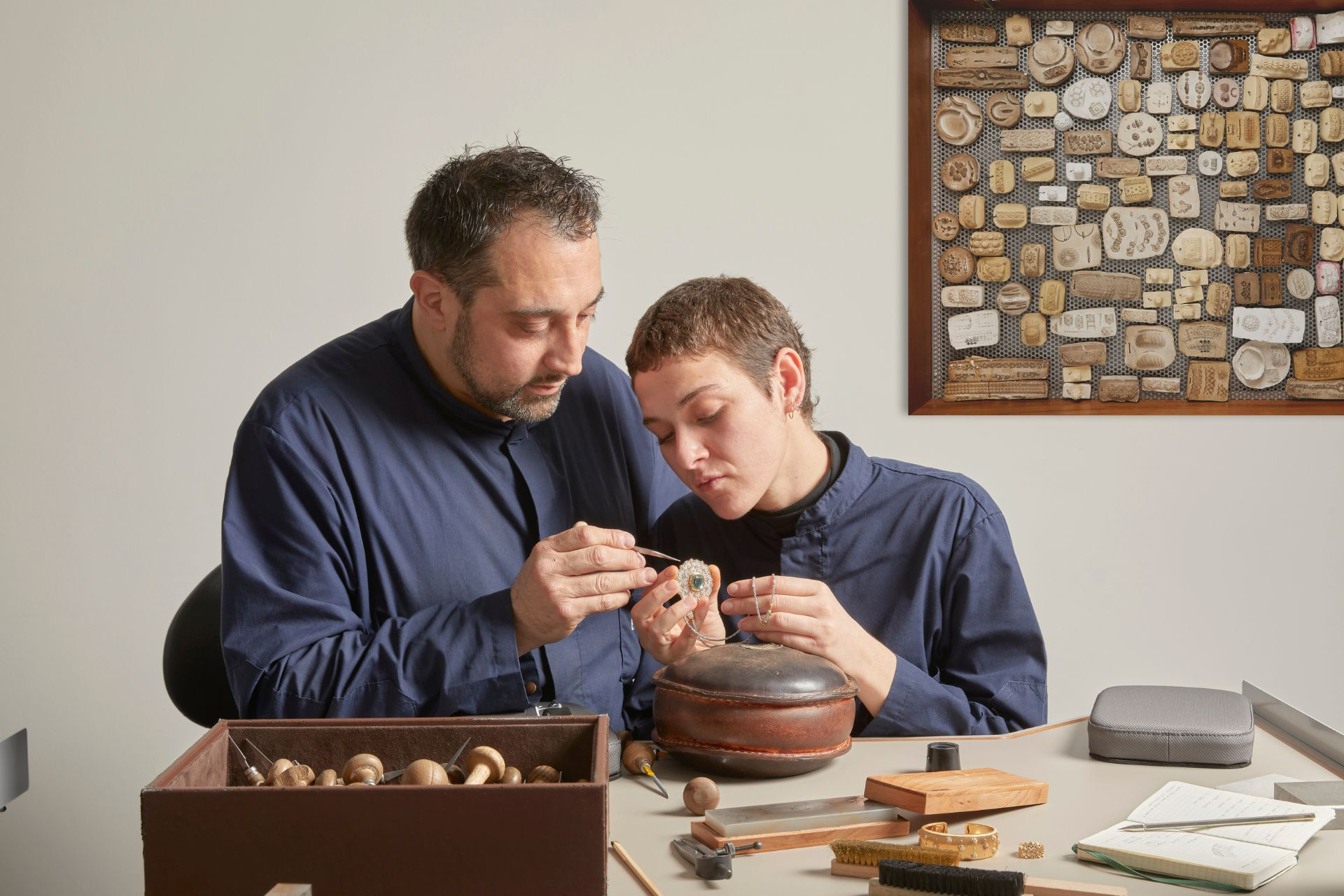 A man and a woman work on some jewellery at Buccellati in Milan