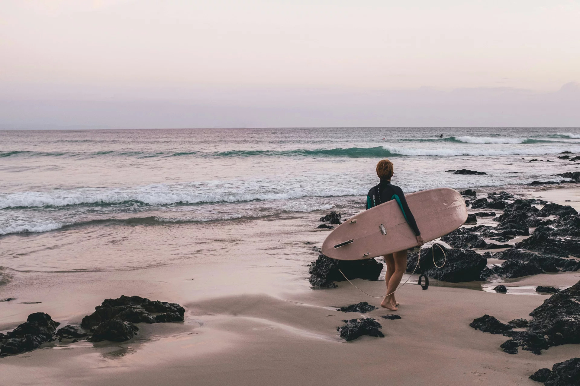 A teenager with a surf board in Australia