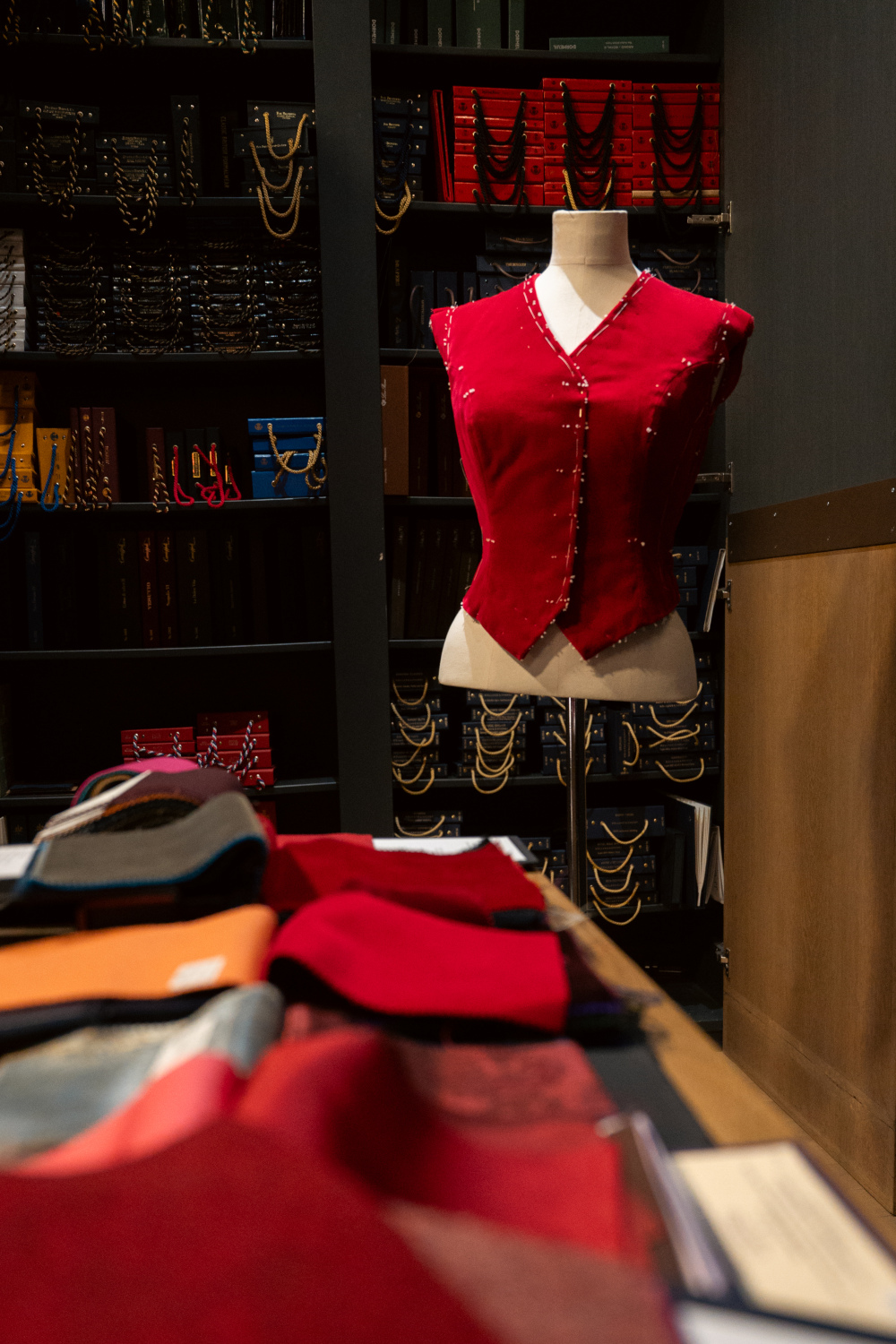 Mannequin dressed in red waistcoat by work bench