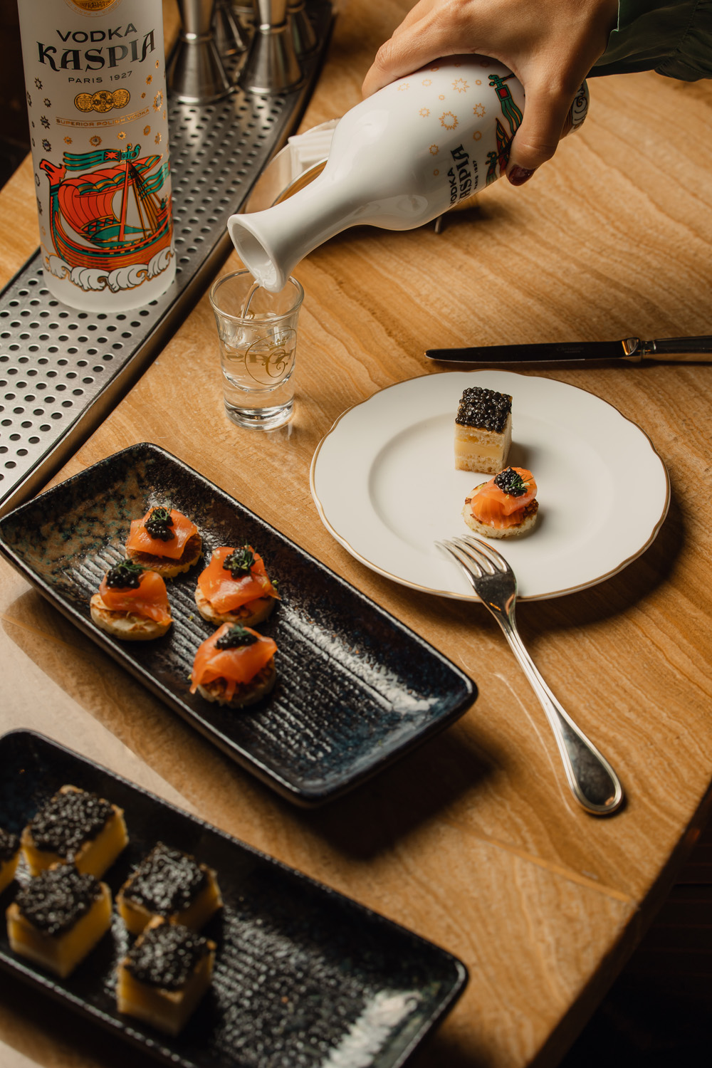 Caviar and a vodka shot being poured