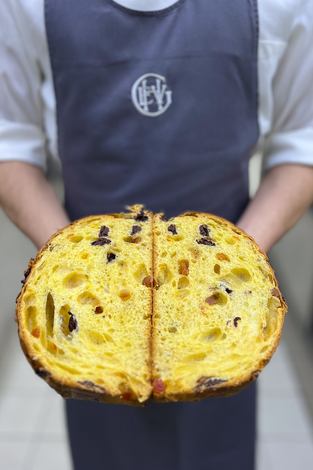 A chef holding a sliced open Panettone