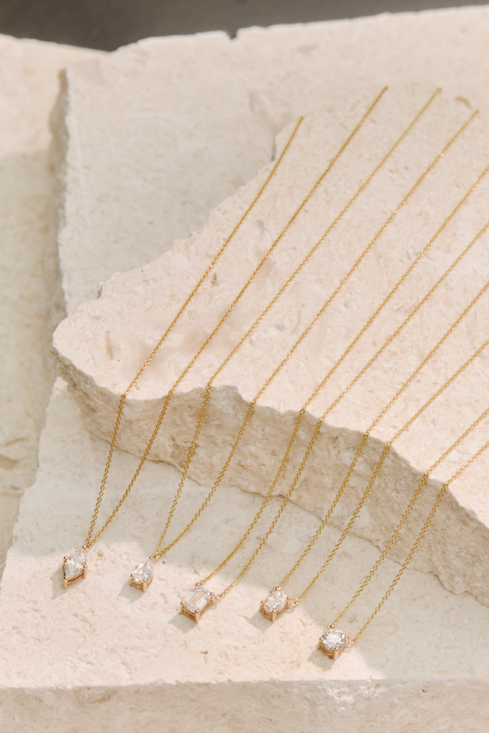 Necklaces lined up on stone slab