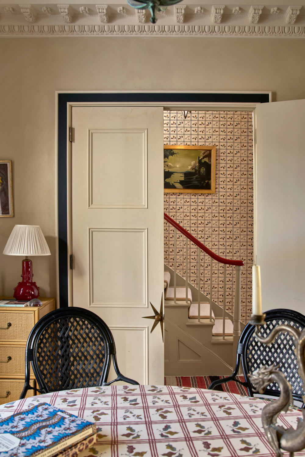Table and chairs, with open door behind