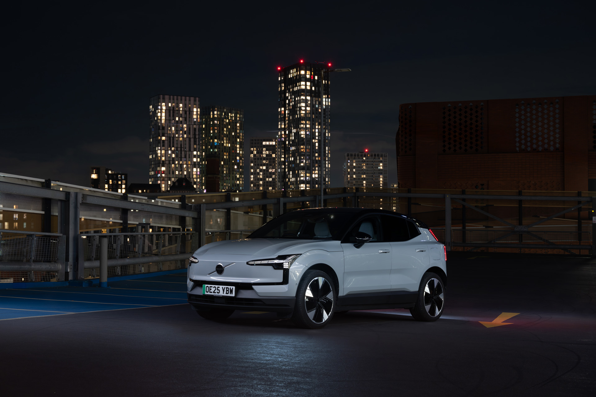 Volvo EX30 against a city skyline at night