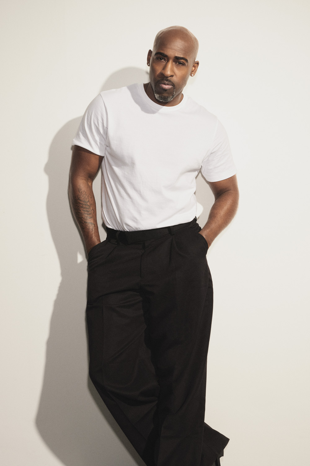 Daniel Francis wearing a white T shirt and black trousers