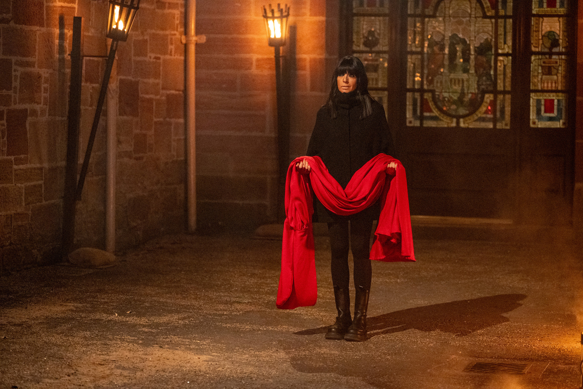 Claudia Winkleman holding the Secret Traitor's cloak