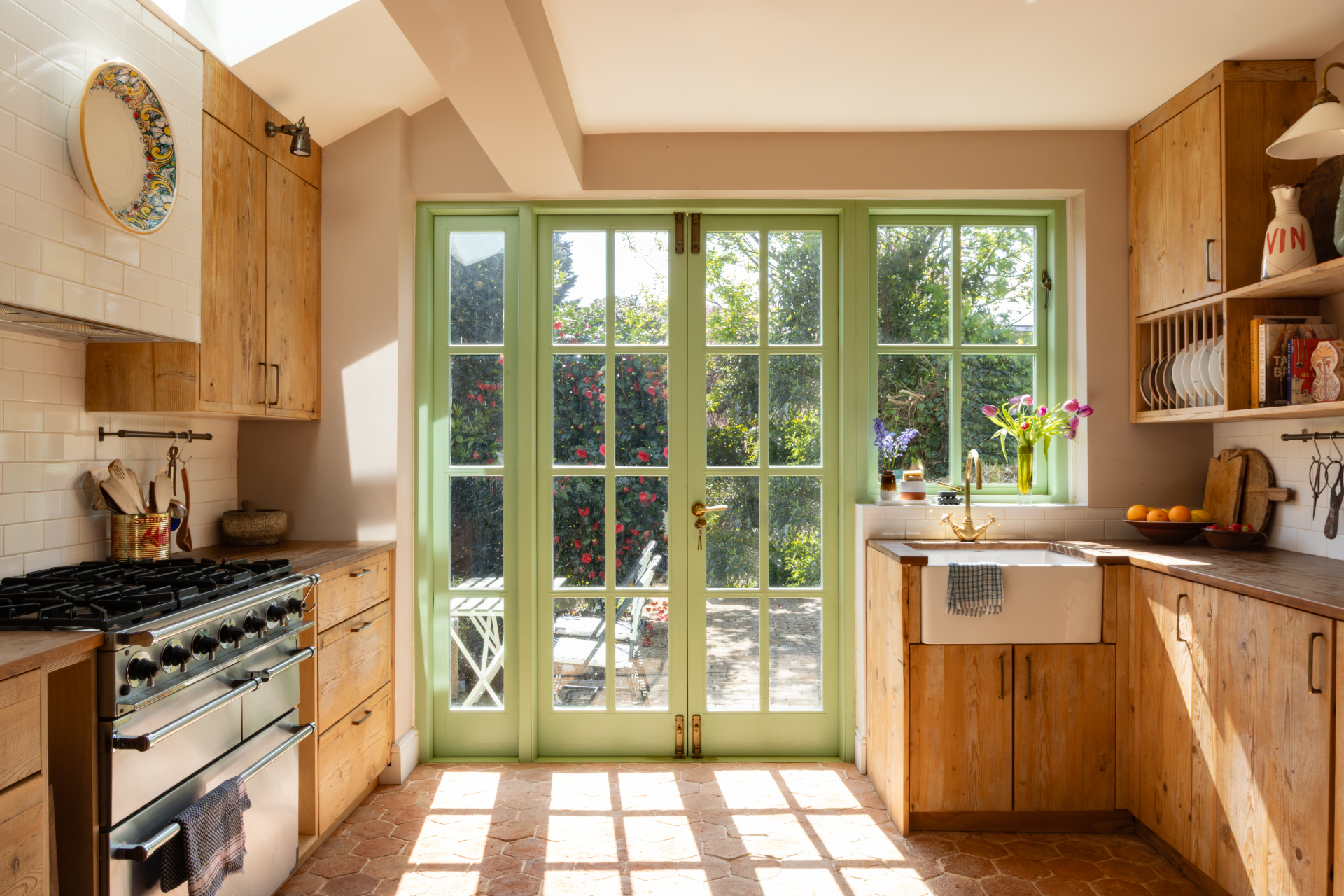 Kitchen with wooden cabinets and green French doors | Ali Childs' home