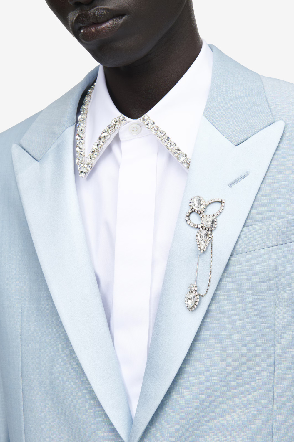 Close up of man wearing brooch on lapel