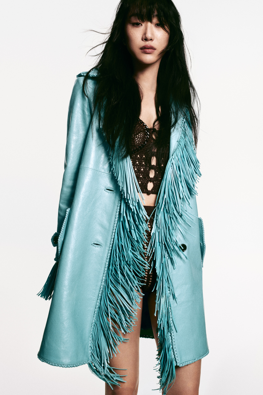 Woman wearing blue fringe coat