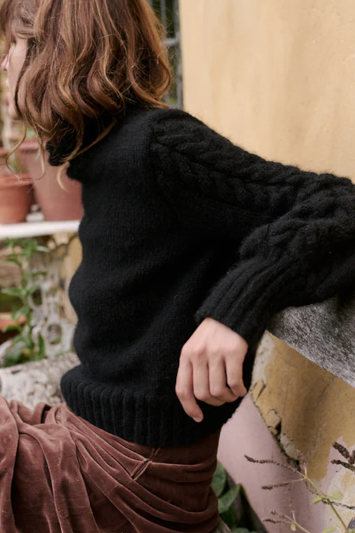 Woman wearing black knit jumper