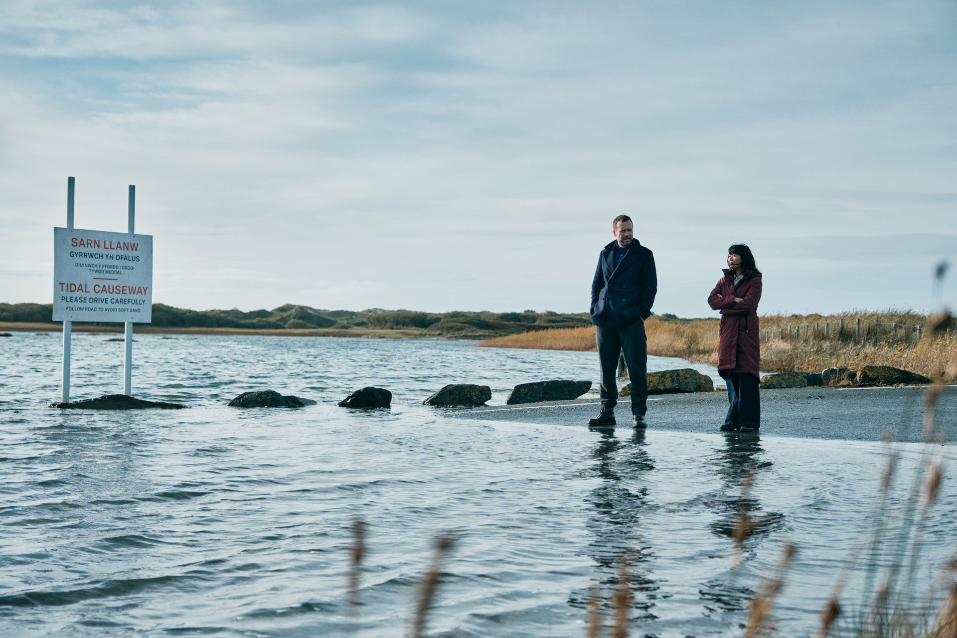 Rafe Spall as Eric Bull & Naomi Yang as Jess Deng in Under Salt Marsh