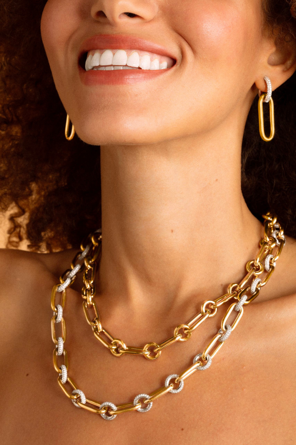 Woman wearing yellow gold necklaces and earrings