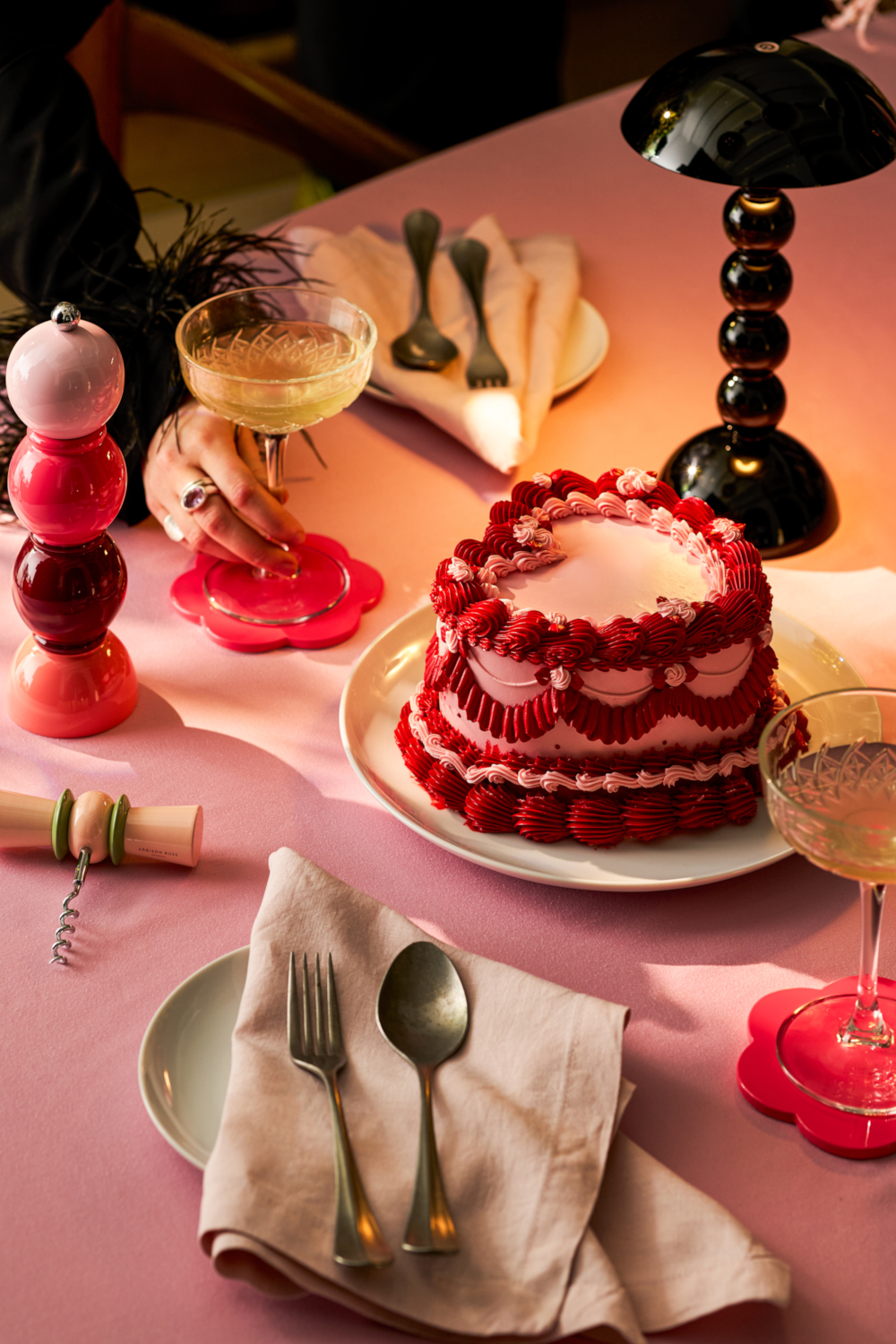 Heart cake on able with glass of champagne and napkins