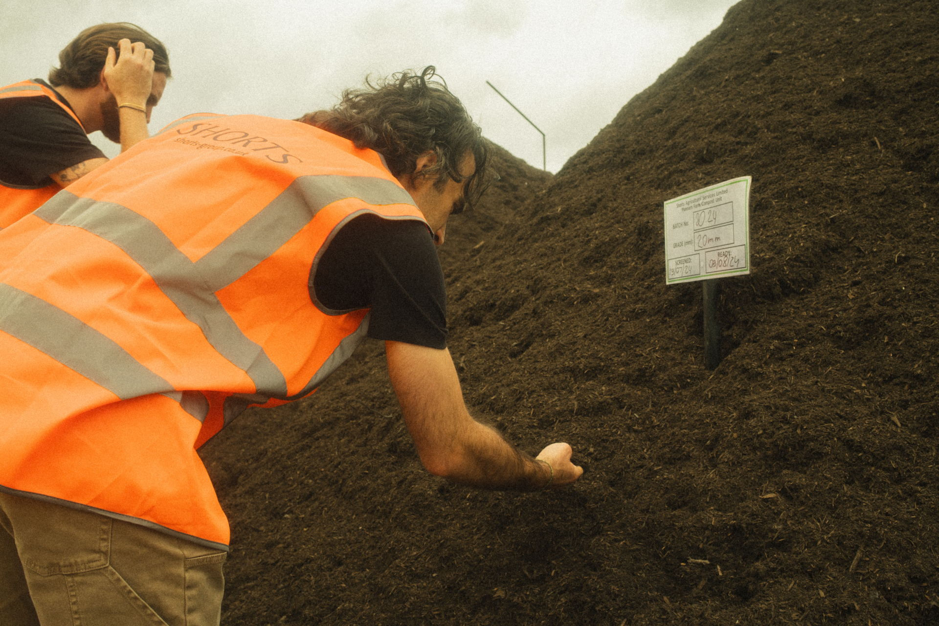 People sifting through compost