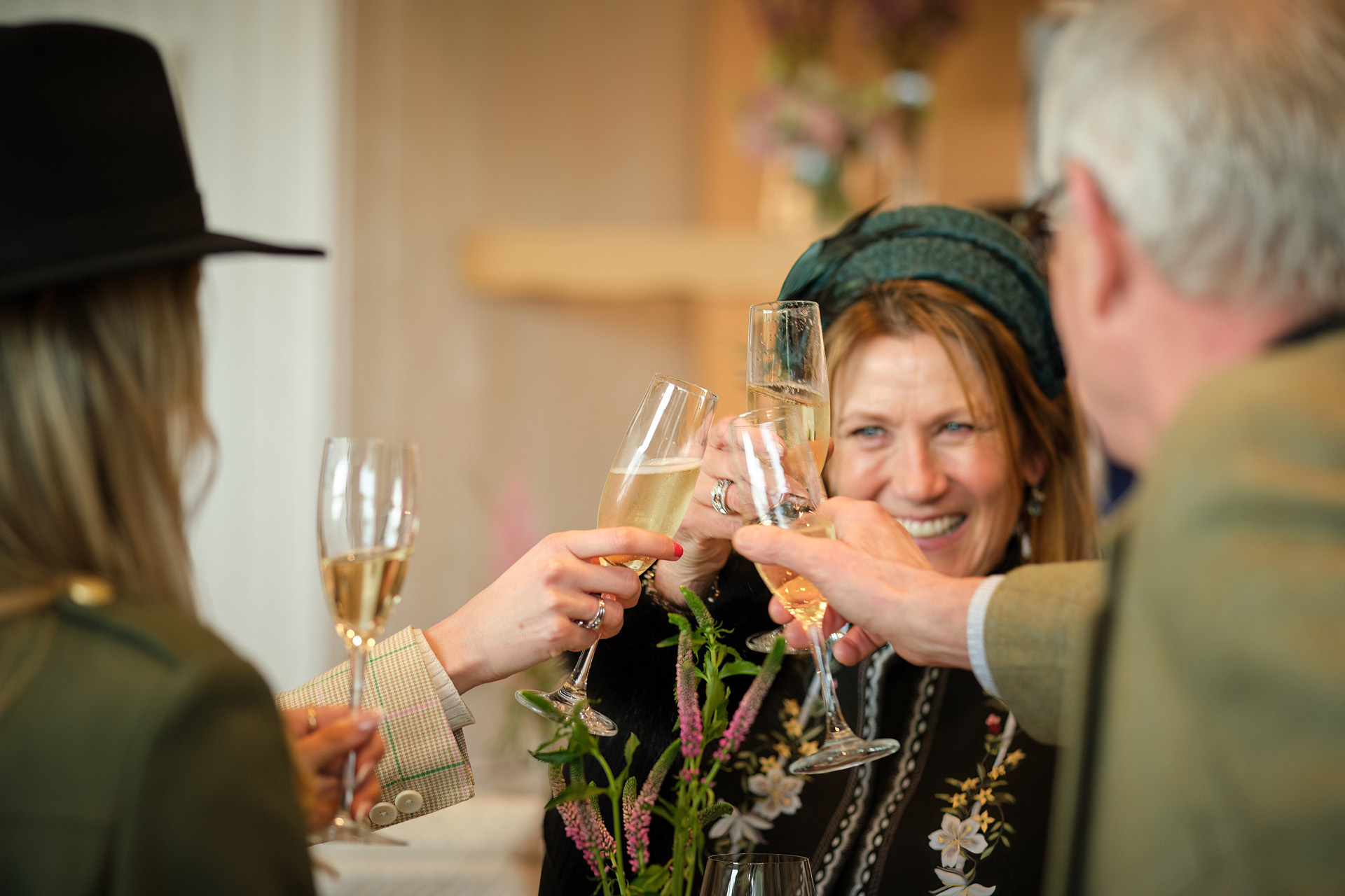 People clinking glasses of fizz at Cheltenham