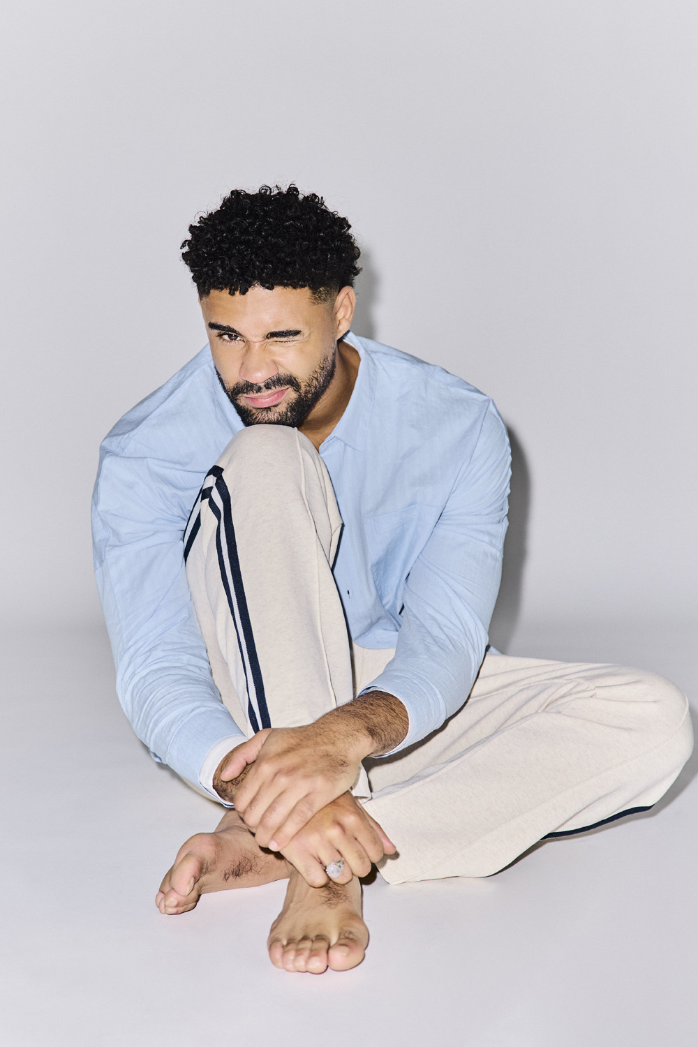 Darragh Hand winking & sitting on the floor