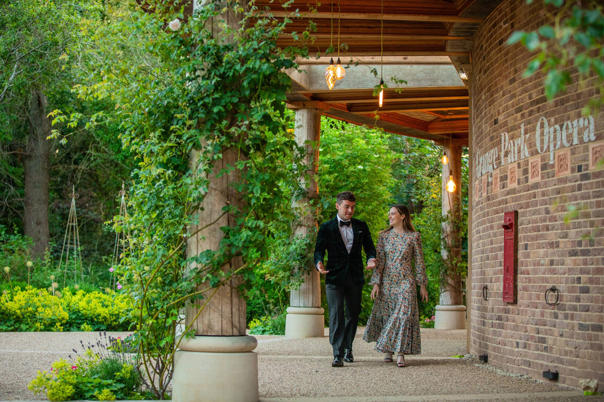 Two guests walking beside the opera house at Grange Park Opera