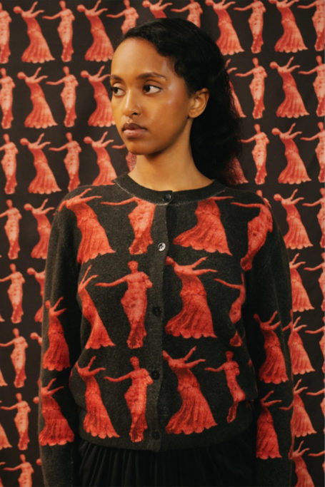 Woman in black and red cardigan