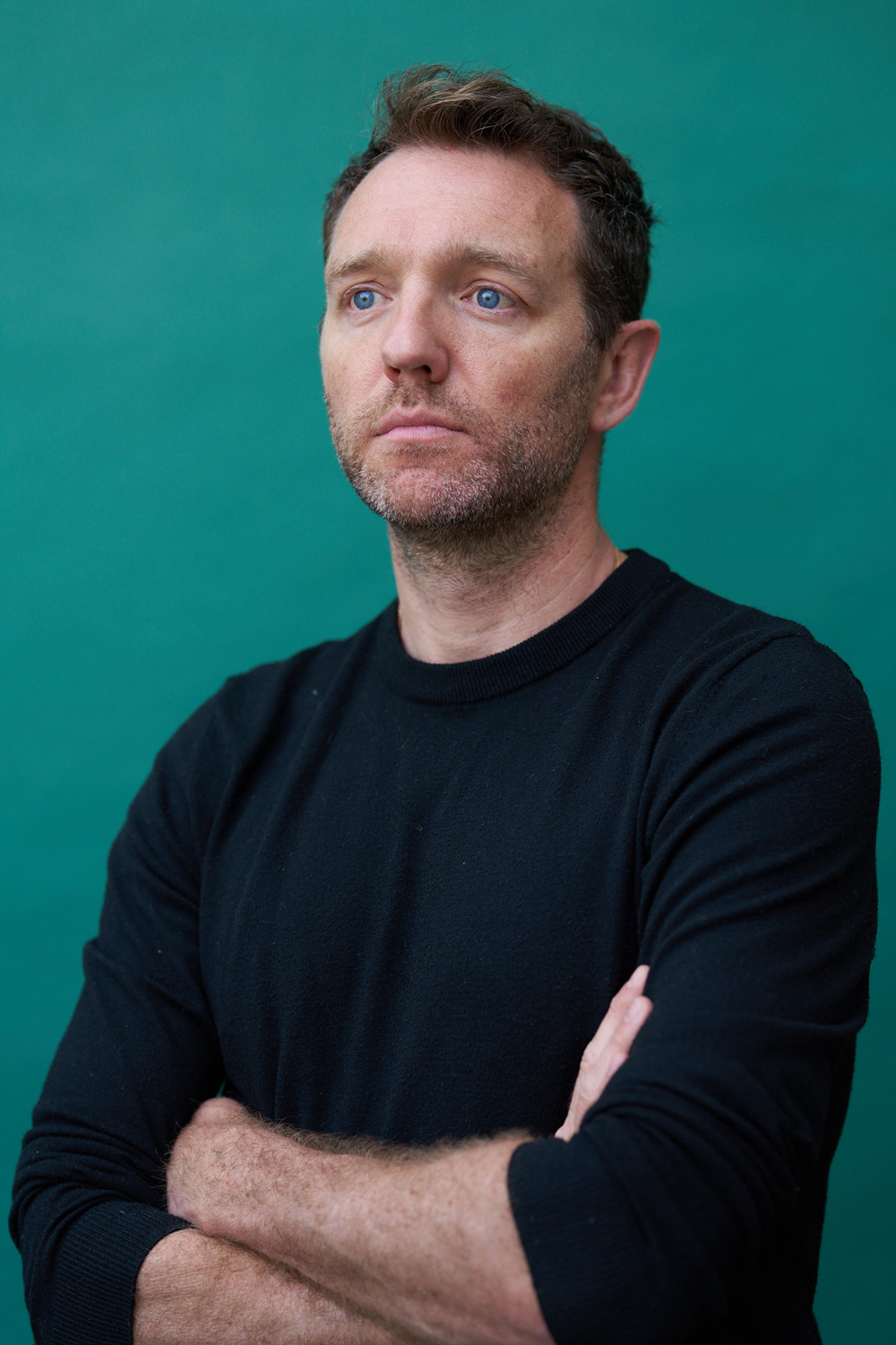 Tom McKay with his arms crossed