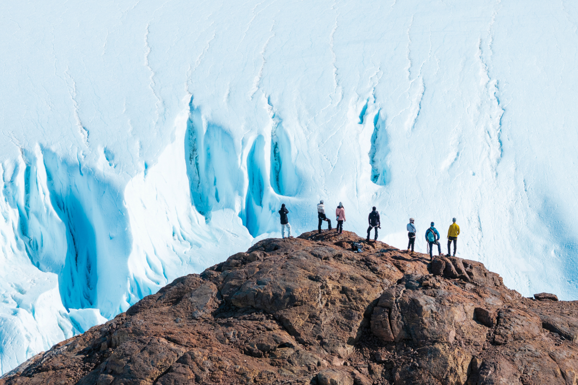 People hiking surrounded by ice