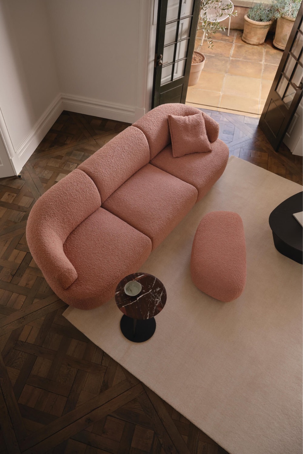 Pink sofa in open plan room