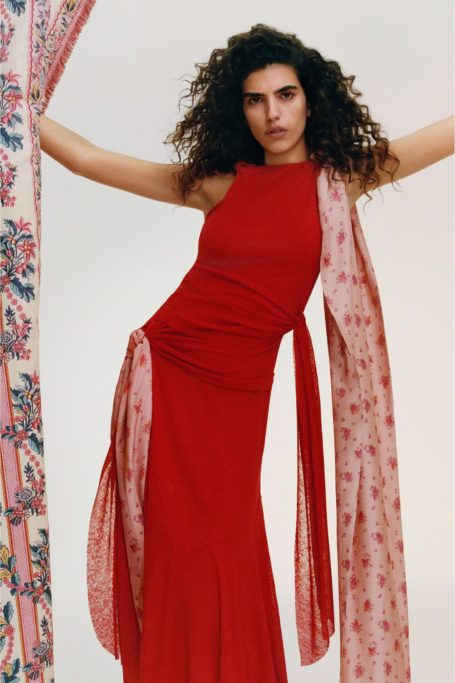 Woman wearing red dress from B Corp fashion brand GANNI