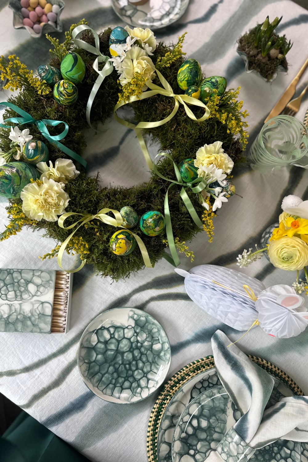 Table set with egg-filled wreath