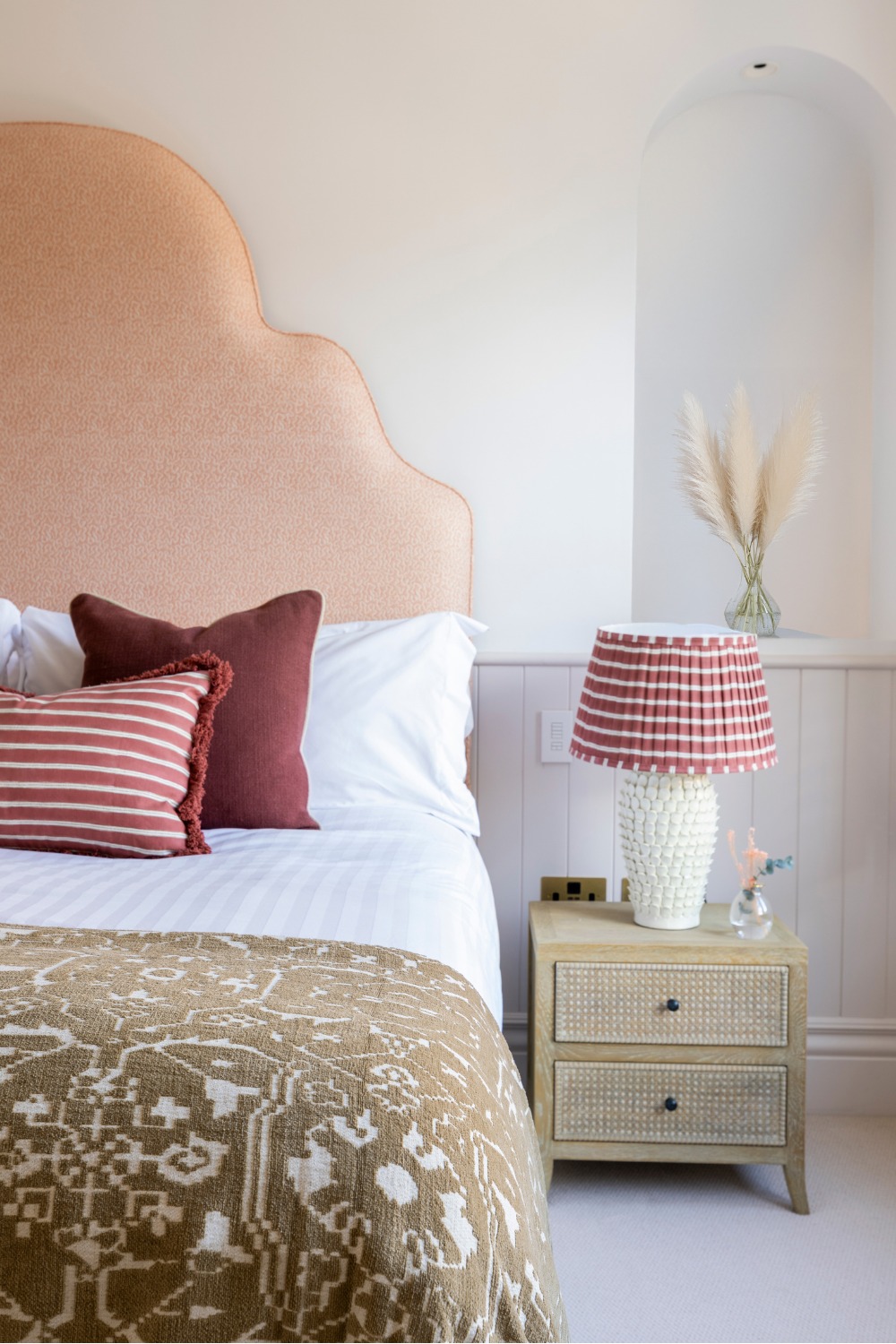 Bedroom with large pink headboard