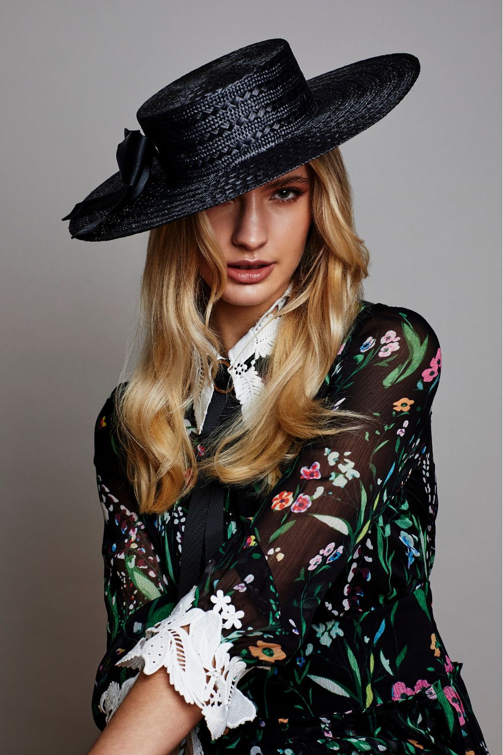 Woman in black hat and top