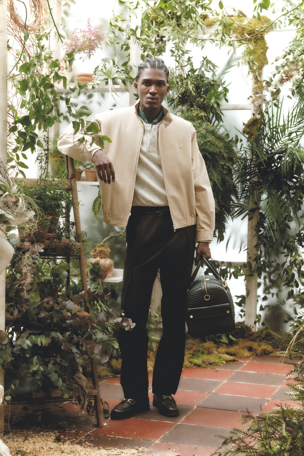 Man stood in greenhouse wearing Varisty-inspired menswear