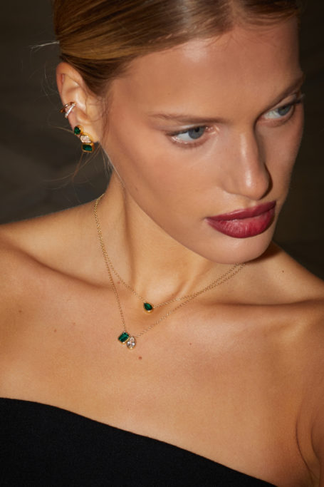 Close up of woman wearing necklace stack from Aya