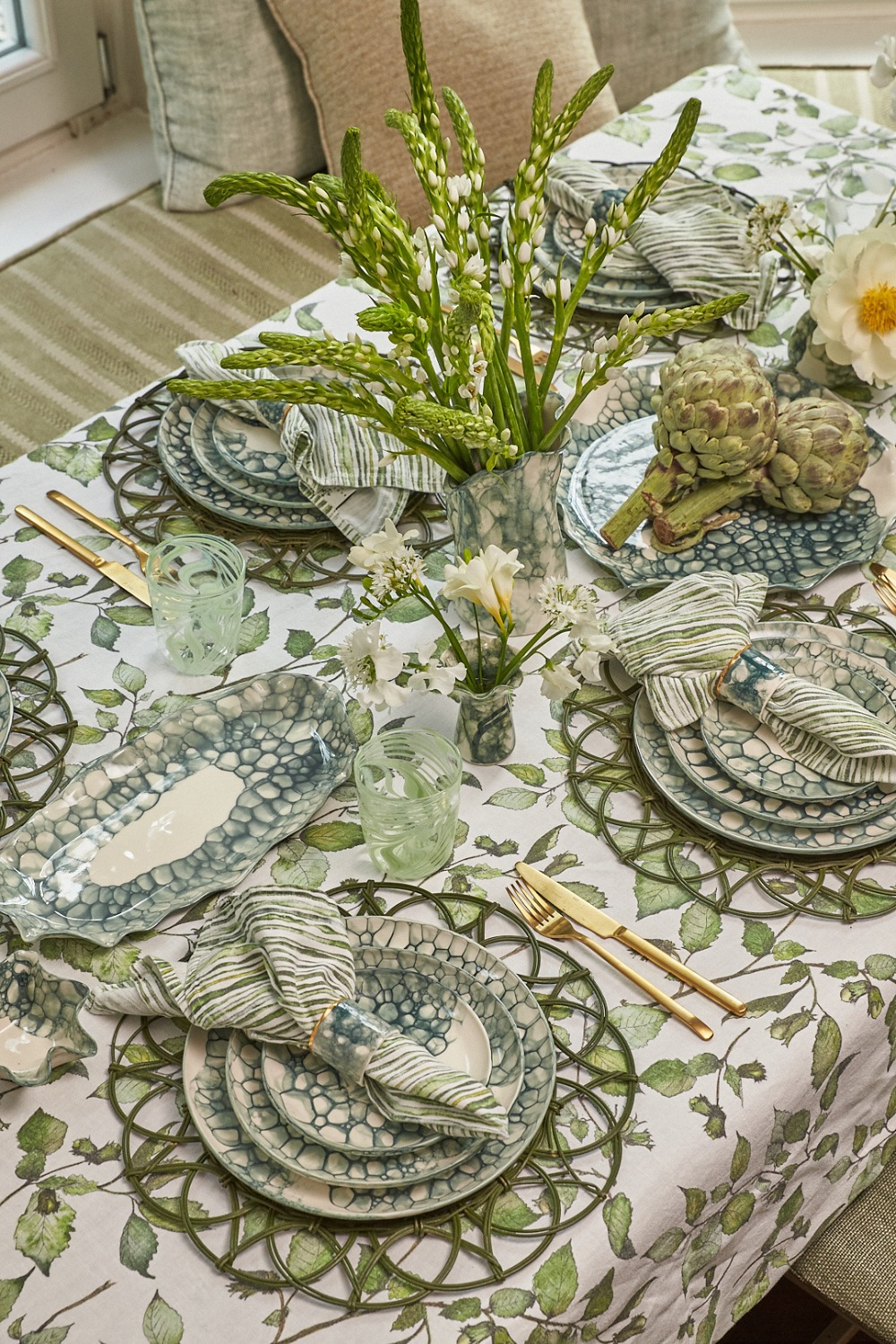 Table set with blue dishware and tablecloth