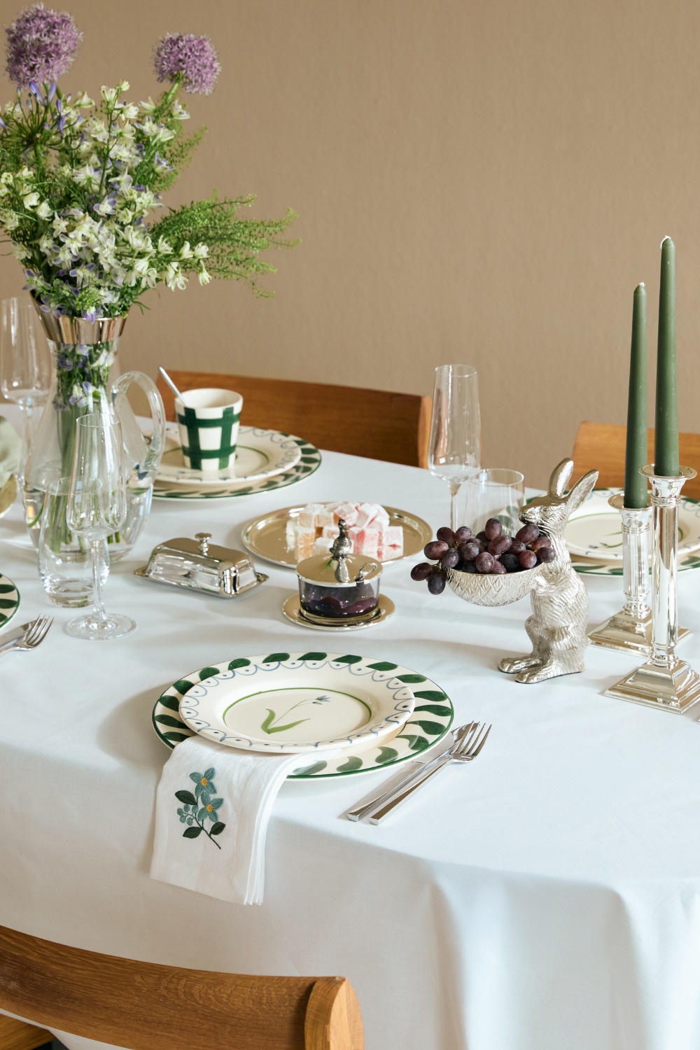 Table set with white cloth and Easter-themed decor