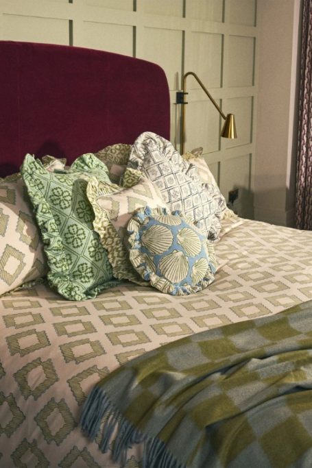 Bed made with patterned bedding from British B Corp home brand TBCo