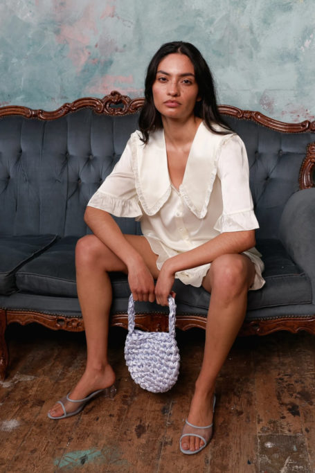 Woman wearing white loungewear set from It's 9pm