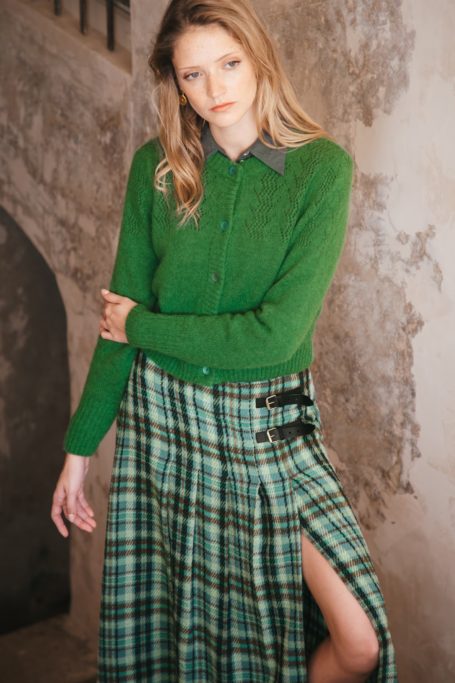 Woman in green cardigan and kilt