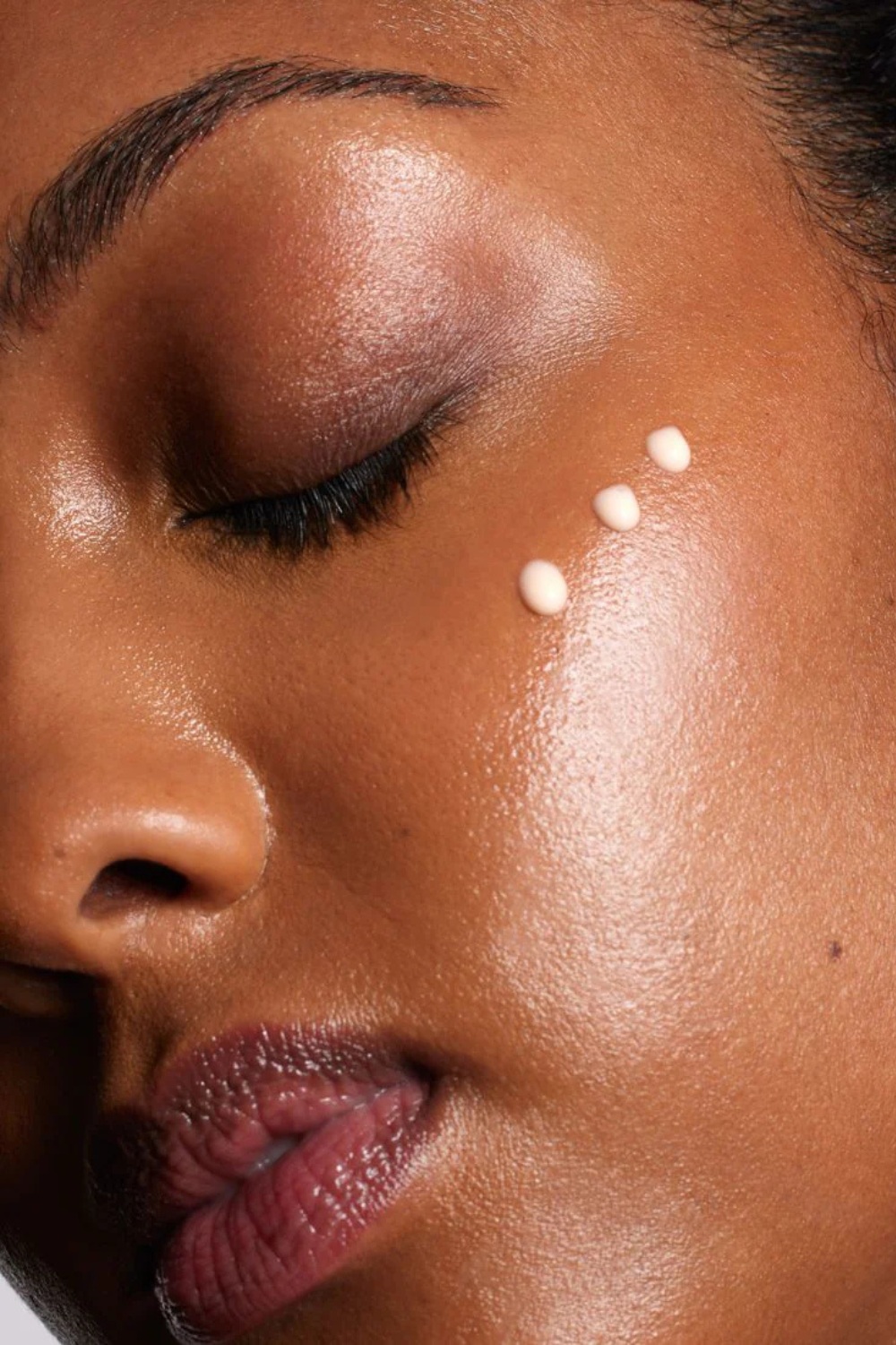 Close up of face with moisturiser on the cheekbone