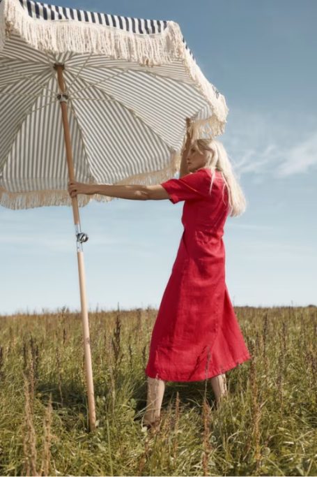Woman in red dress holding parasol