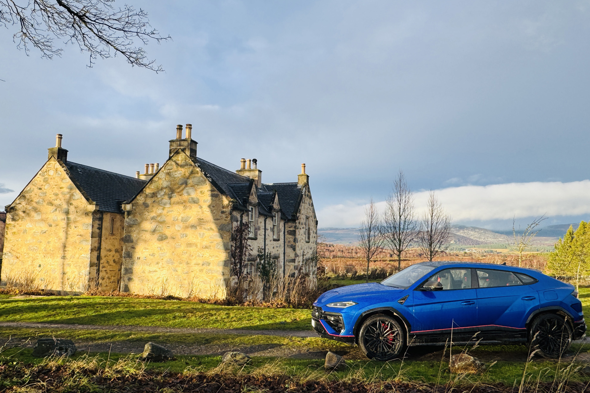 Blue Lamborghini Urus SE outside Killiehuntly Farmhouse